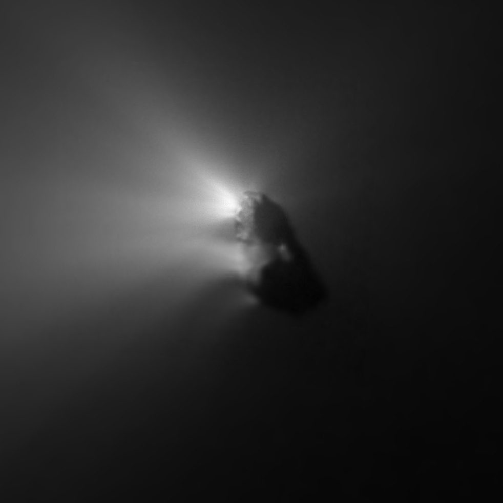 Dark irregular lump in monochrome with bright jets streaming away to one side